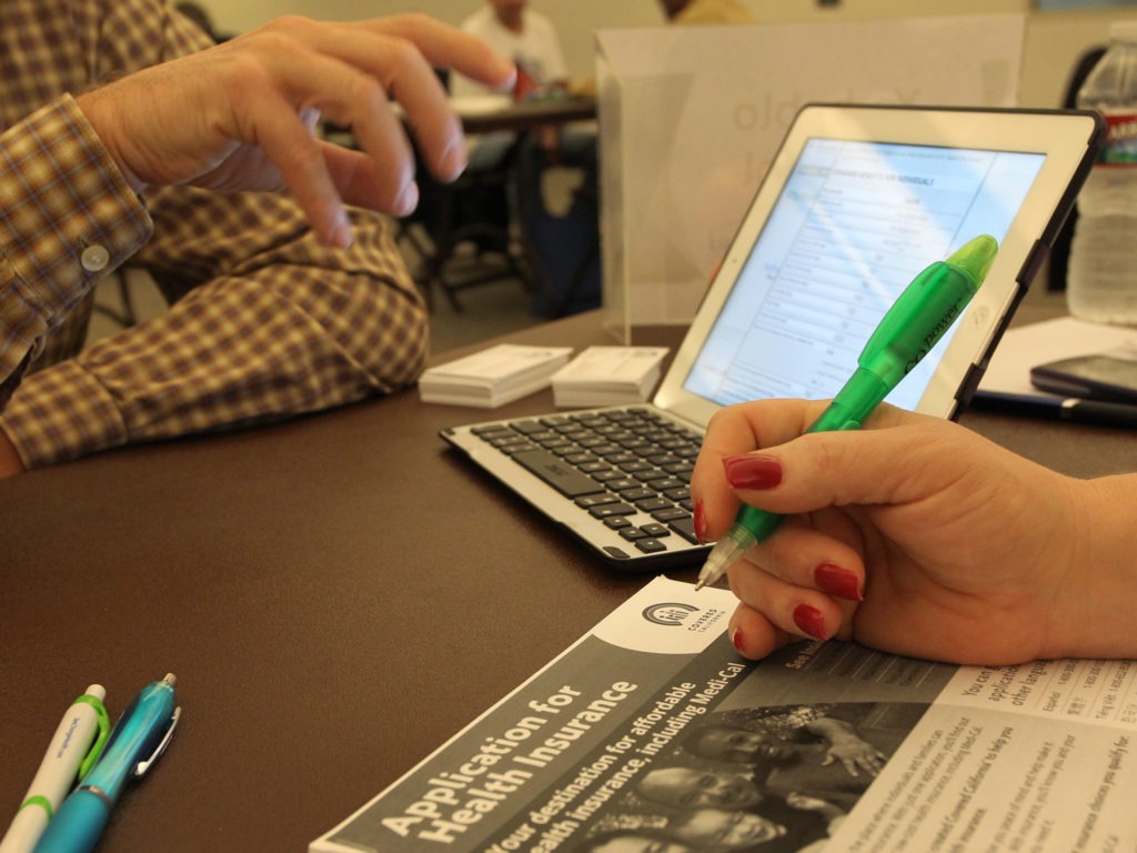 filling out health insurance sign-up paperwork