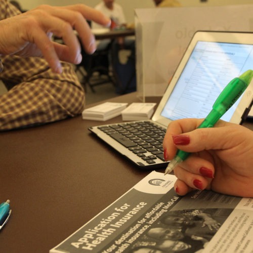 filling out health insurance sign-up paperwork