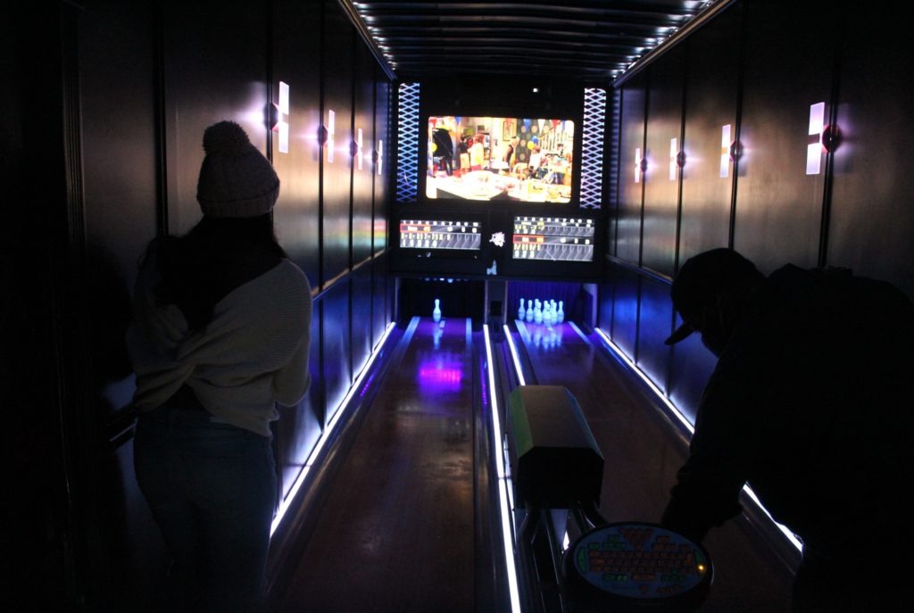 The neon-lit Luxury Strike mobile bowling alley includes two 25-foot lanes, an automatic ball return, automatic pin-resetters and even digital scorekeepers. Laura Herberg/NPR