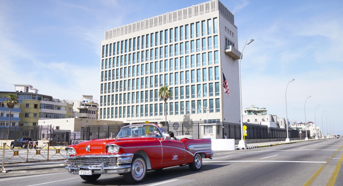 A car drives past the U.S. Embassy in Havana in 2019. Dozens of Americans working at U.S. diplomatic missions in Cuba and China in recent years have suffered from ailments that have included headaches, balance problems and memory loss. Pablo Martinez Monsivais/AP