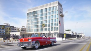 A car drives past the U.S. Embassy in Havana in 2019. Dozens of Americans working at U.S. diplomatic missions in Cuba and China in recent years have suffered from ailments that have included headaches, balance problems and memory loss. Pablo Martinez Monsivais/AP