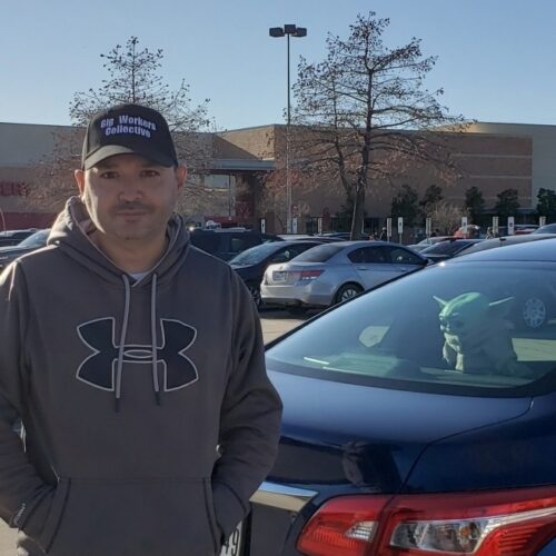 Willy Solis outside his workplace in a parking lot