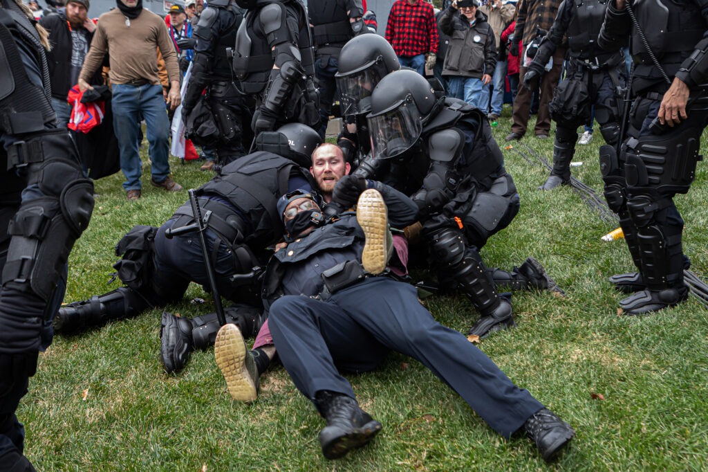 A pro-Trump protester resists arrest on Wednesday. There were few arrests in relation to the scope of the unrest as of Wednesday night. CREDIT: Michael Nigro/Sipa USA via Reuters