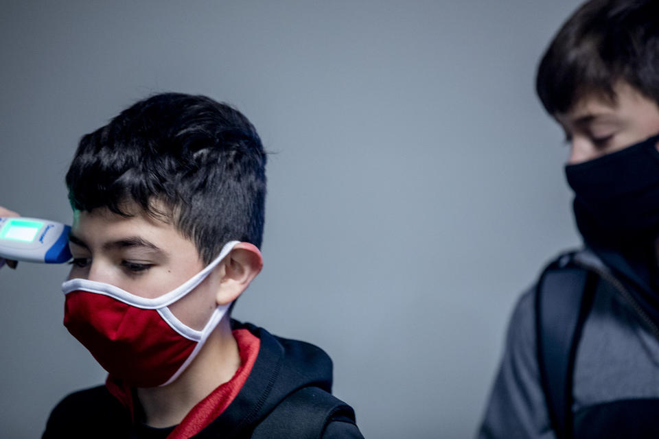 Moses Lake seventh grader Gabriel Barreto has his temperature taken during the health check-in before school starts at Chief Moses Middle School on Jan. 11, 2020. CREDIT: Dorothy Edwards/Crosscut