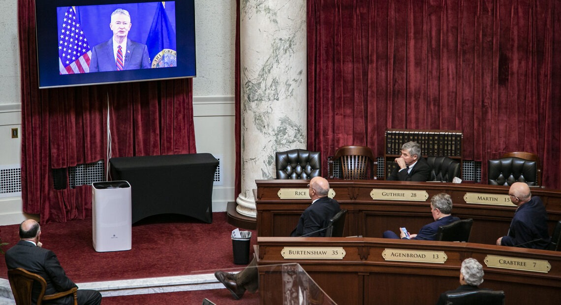 Senators watch Gov. Brad Little’s 2021 State of the State address from the floor of the Senate chambers. Because of COVID-19 precautions, Little delivered the address remotely instead of in the traditional joint gathering of the House and Senate chambers. CREDIT: Nik Streng/ Idaho EdNews