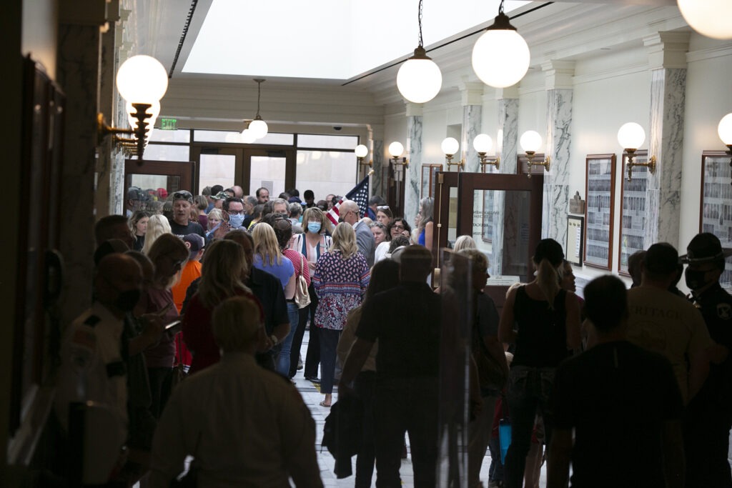 Hundreds of citizens (most unmasked) crowd the Statehouse hallways during a special legislative session in August. That contentious special session, combined with the state’s rising coronavirus case numbers, has education leaders uneasy about the 2021 session, which starts Monday. CREDIT: Sami Edge/Idaho Education News