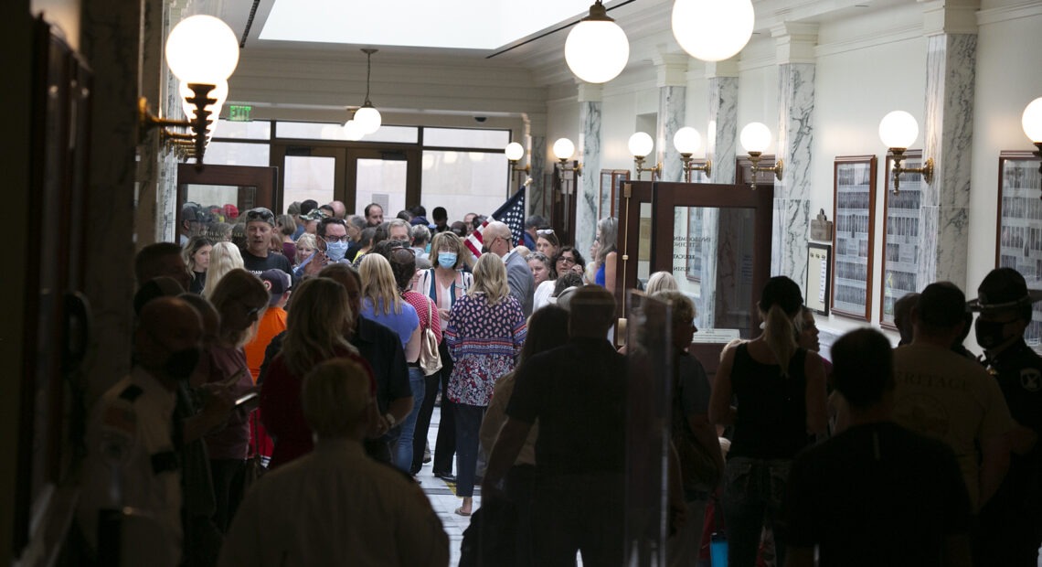 Hundreds of citizens (most unmasked) crowd the Statehouse hallways during a special legislative session in August. That contentious special session, combined with the state’s rising coronavirus case numbers, has education leaders uneasy about the 2021 session, which starts Monday. CREDIT: Sami Edge/Idaho Education News