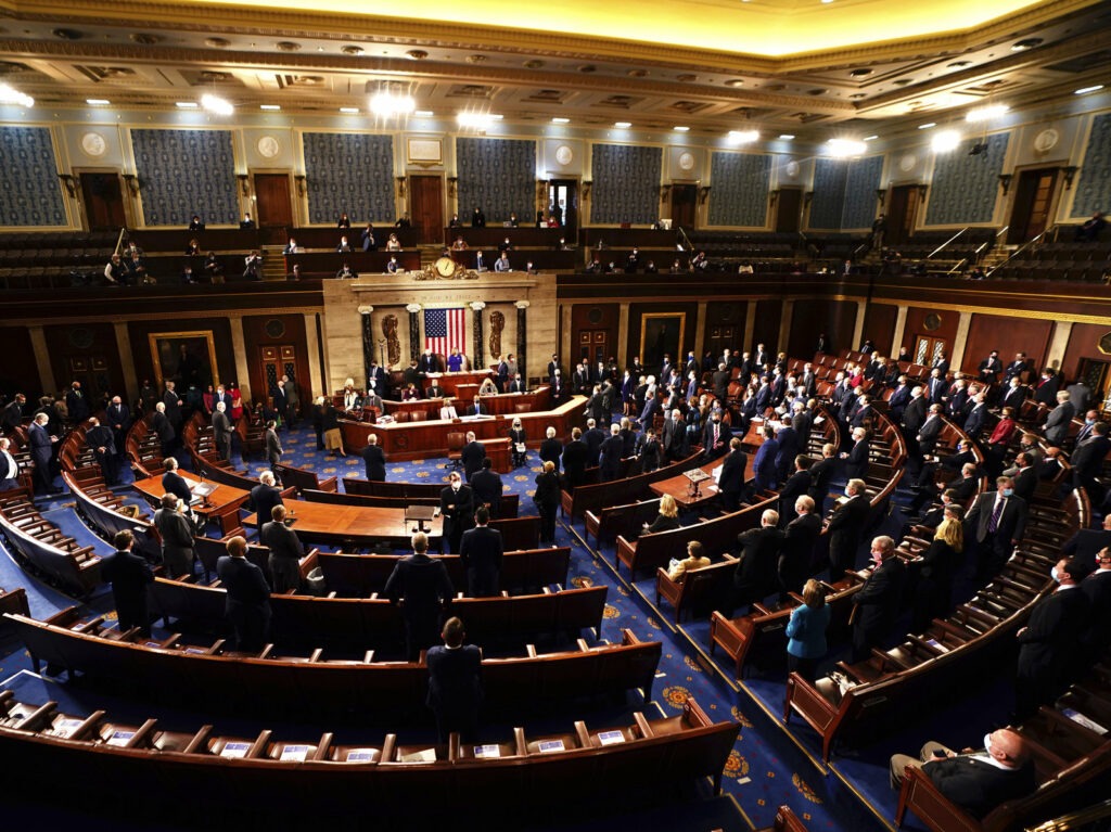 Speaker of the House Nancy Pelosi, D-Calif., and Vice President Mike Pence officiated as a joint session of the House and Senate worked to confirm the Electoral College votes cast in November's election. Jim Lo Scalzo/AP