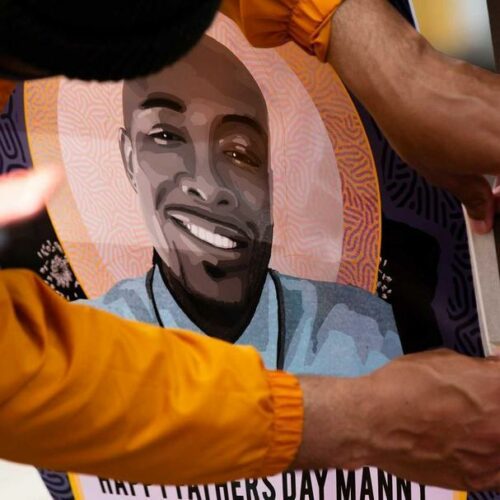 Community members gathered in June for a celebration of life for Manuel Ellis, who was killed by Tacoma police in March. In this photo, one of the attendees hangs a flyer with Ellis’ image that says “Happy Father’s Day Manny.” CREDIT: Parker Miles Blohm/KNKX