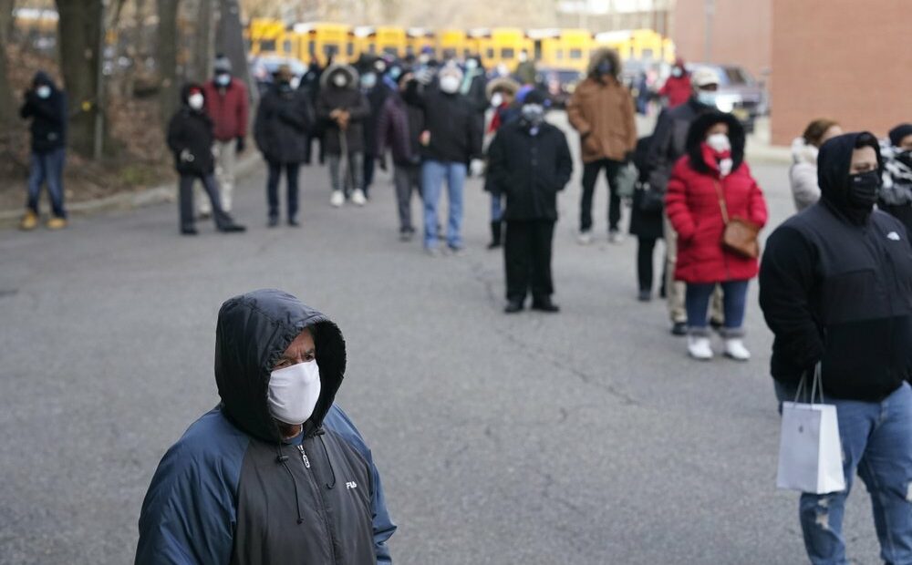 People wait in line for the COVID-19 vaccine in Paterson, N.J., Thursday, Jan. 21, 2021. Some hospitals around the U.S. are facing complaints about favoritism and line-jumping after their board members and donors received COVID-19 vaccinations or offers for inoculations. CREDIT: Seth Wenig/AP