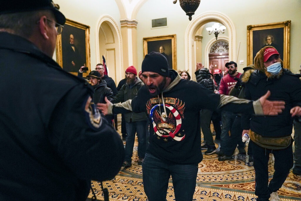 Protesters gesture to U.S. Capitol Police in the hallway outside of the Senate chamber inside the Capitol on Wednesday. Manuel Balce Ceneta/AP