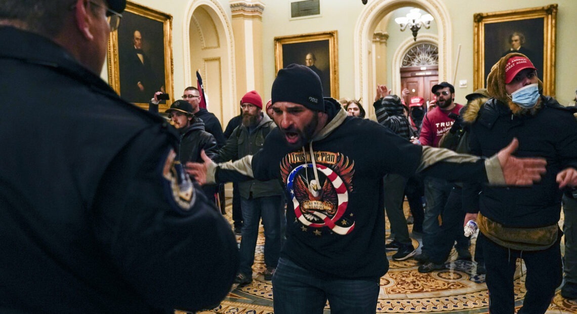 Protesters gesture to U.S. Capitol Police in the hallway outside of the Senate chamber inside the Capitol on Wednesday. Manuel Balce Ceneta/AP