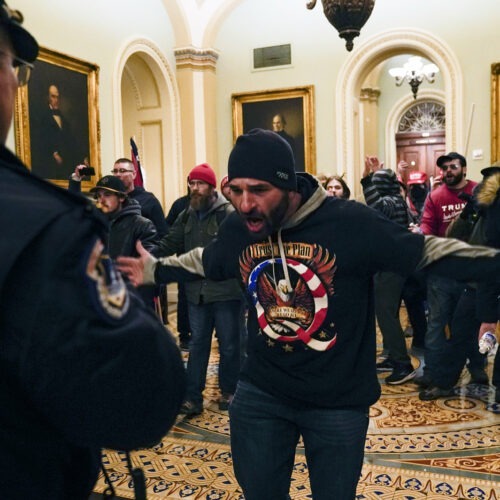Protesters gesture to U.S. Capitol Police in the hallway outside of the Senate chamber inside the Capitol on Wednesday. Manuel Balce Ceneta/AP