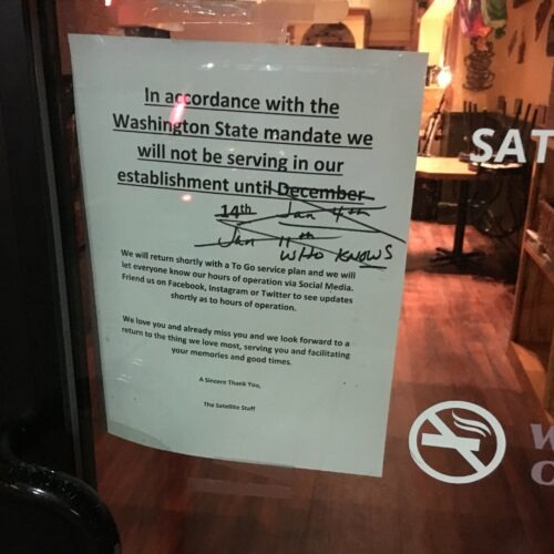 Sign on restaurant door in Spokane saying when it will reopen from covid closure with multiple dates crossed out and finally saying "who knows"