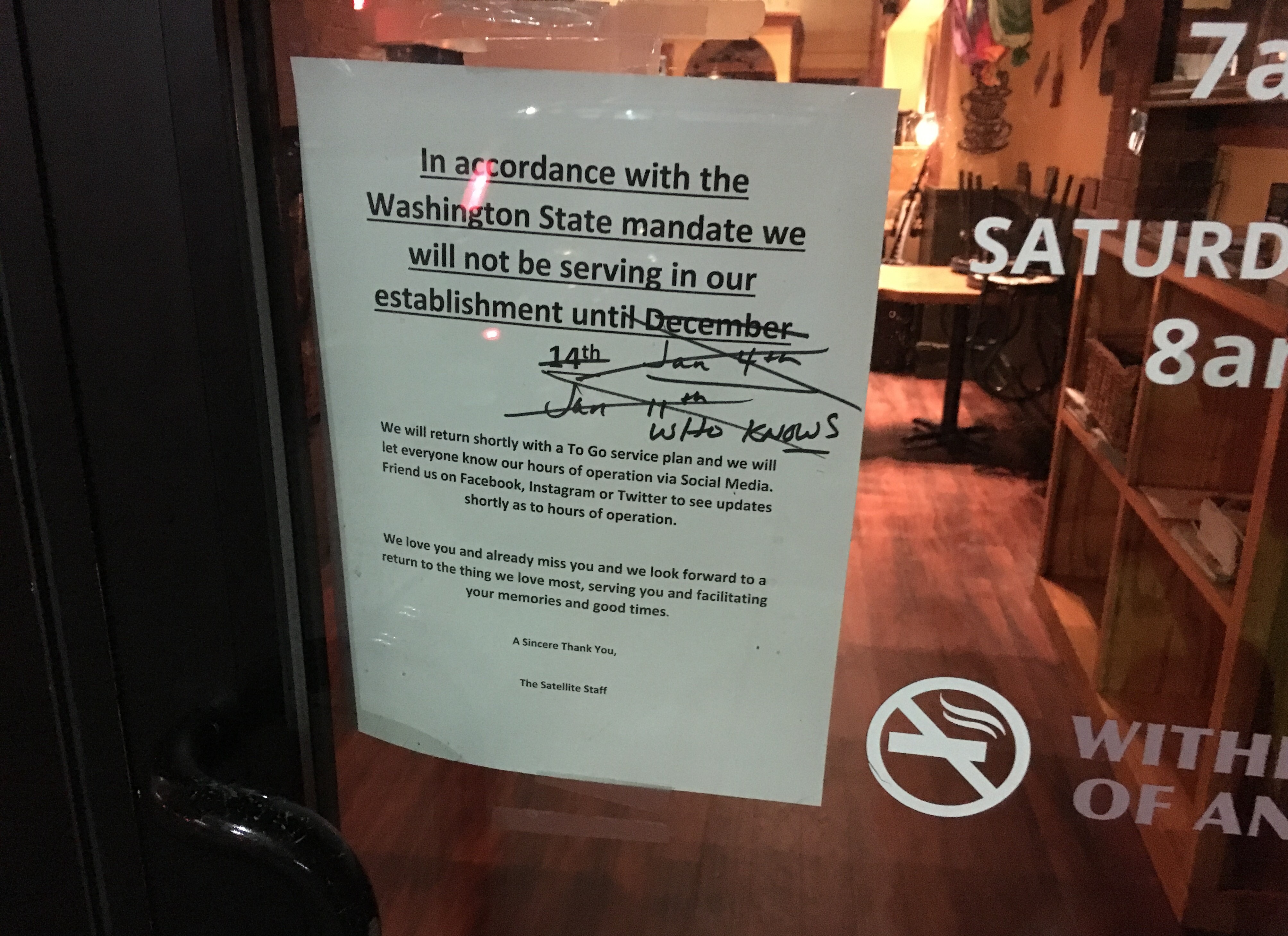 Sign on restaurant door in Spokane saying when it will reopen from covid closure with multiple dates crossed out and finally saying "who knows"