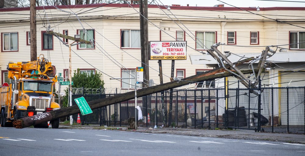 A utility pole is toppled along East Marginal Way South at South Myrtle Street in Seattle, Wednesday, Jan. 13, 2021, following an overnight storm. CREDIT: Mike Siegel/The Seattle Times via AP