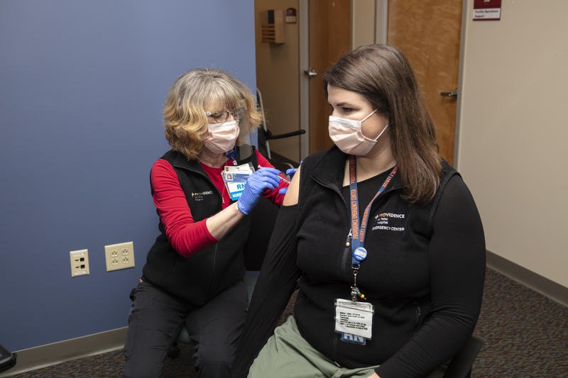 Nurse Elizabeth Vadnais administers the COVID-19 vaccine to fellow nurse Ashlynn Strode. Courtesy of Providence of SW Washington