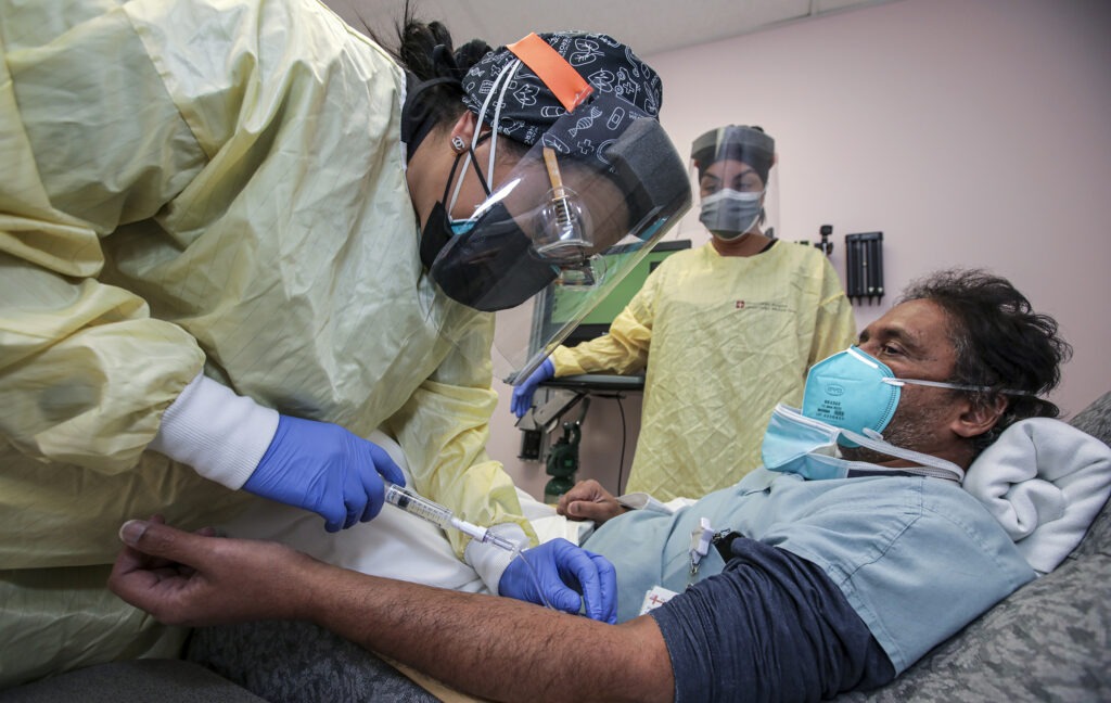 Nurse Salina Padilla prepares an infusion of a COVID-19 antibody treatment at Desert Valley Hospital in Victorville, Calif., in December. CREDIT: Irfan Khan/Los Angeles Times via Getty Images