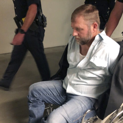 Anti-government activist Ammon Bundy is wheeled from the Idaho Statehouse in Boise, on Aug. 26, 2020. It was his second arrest for trespassing in two days. CREDIT: Keith Ridler/AP