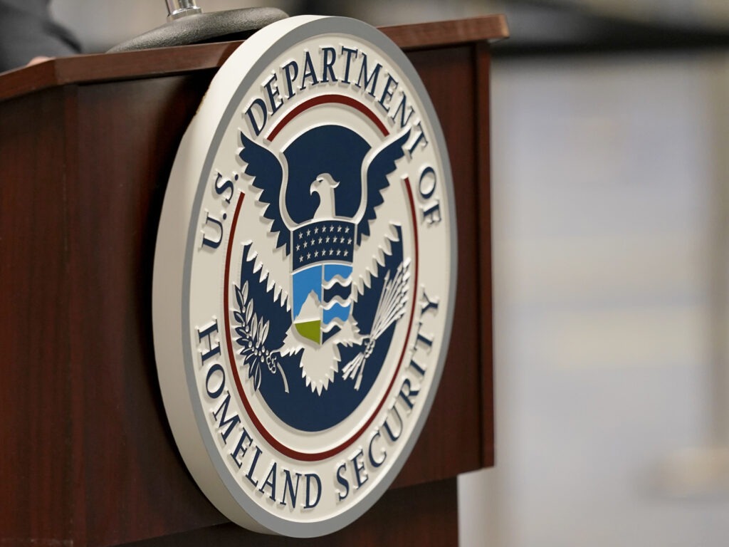 A U.S. Department of Homeland Security plaque is on a podium as international passengers arrive at Miami international Airport where they are screened by U.S. Customs and Border Protection (CBP) using facial biometrics to automate manual document checks required for admission into the U.S. Friday, Nov. 20, 2020, in Miami. Miami International Airport is the latest airport to provide Simplified Arrival airport-wide. (AP Photo/Lynne Sladky)