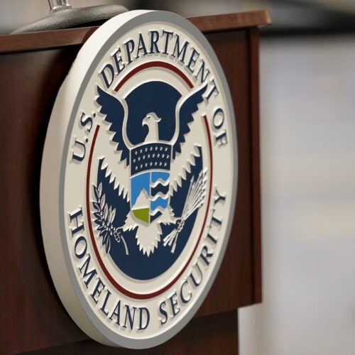 A U.S. Department of Homeland Security plaque is on a podium as international passengers arrive at Miami international Airport where they are screened by U.S. Customs and Border Protection (CBP) using facial biometrics to automate manual document checks required for admission into the U.S. Friday, Nov. 20, 2020, in Miami. Miami International Airport is the latest airport to provide Simplified Arrival airport-wide. (AP Photo/Lynne Sladky)