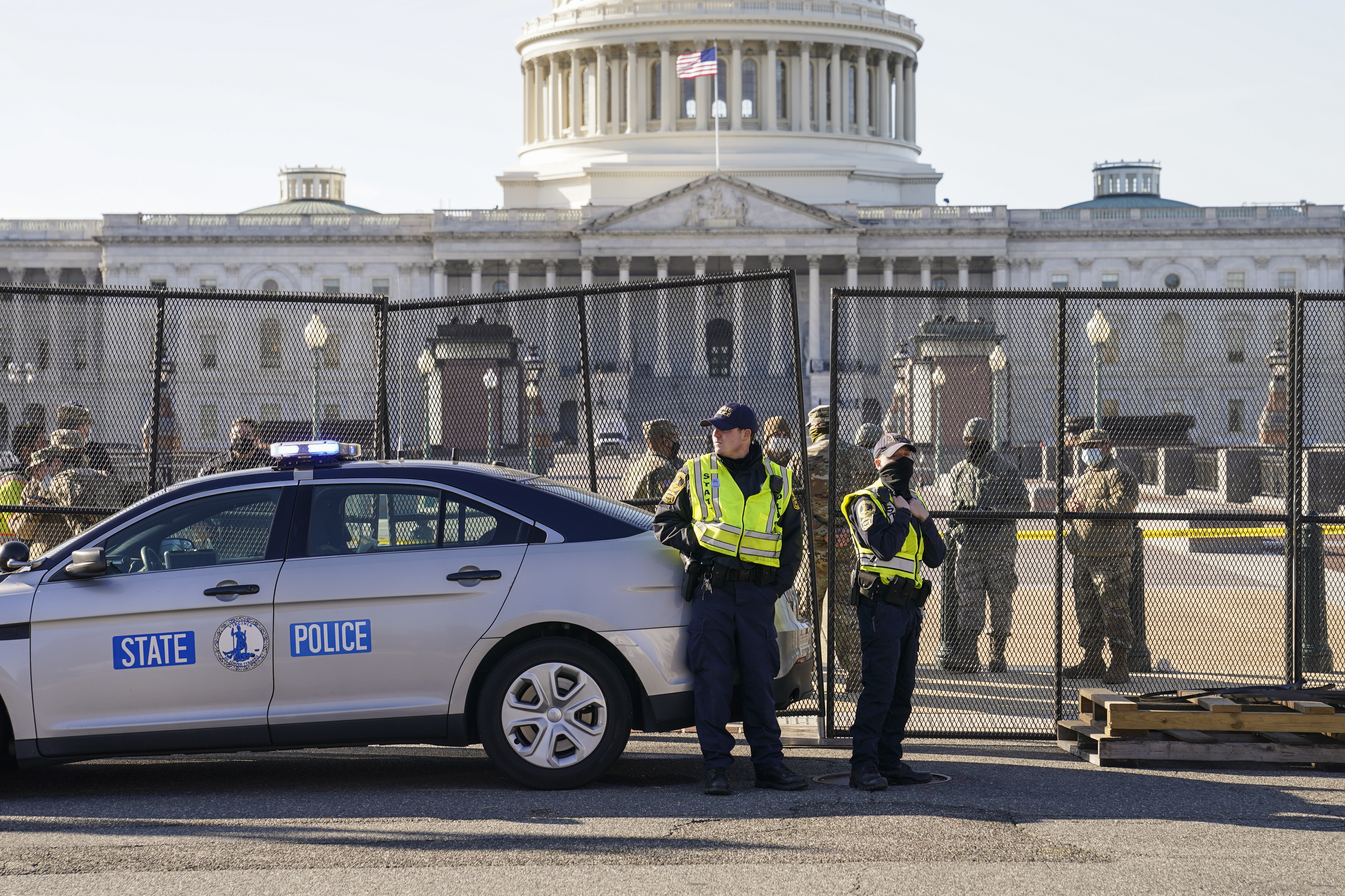 Fencing is placed around the exterior of the Capitol grounds the day after a violent throng of pro-Trump rioters spent hours running rampant through the Capitol. Lawmakers from both parties are criticizing the response by the U.S. Capitol Police. CREDIT: John Minchillo/AP