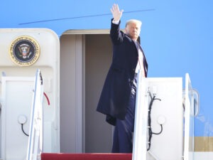 President Donald Trump waves while boarding Air Force One at Joint Base Andrews before a Jan. 12 trip to Texas. He's planning a departure ceremony there on Wednesday, while skipping the traditional send-off at the Capitol. Manuel Balce Ceneta/AP