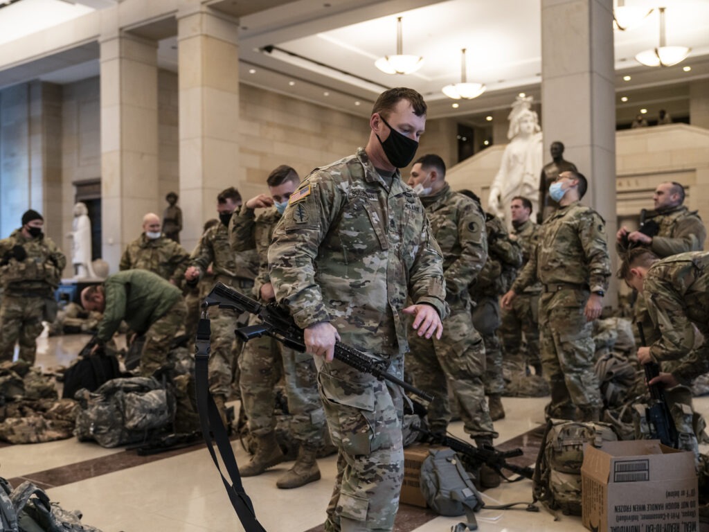 Hundreds of National Guard troops hold inside the Capitol Visitor's Center to reinforce security at the Capitol in Washington on Wednesday. It comes a week after an insurrection at the Capitol and as the House of Representatives is pursuing an article of impeachment against President Trump. CREDIT: J. Scott Applewhite/AP