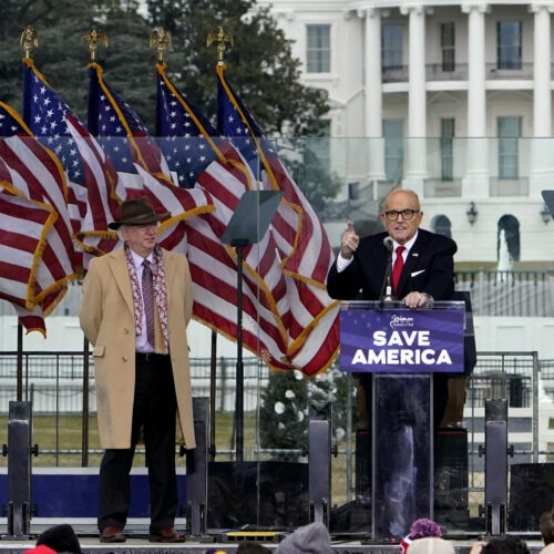 Rudy Giuliani, seen here on Jan. 6 with Chapman University law professor John Eastman, speaks in Washington at a rally in support of former President Donald Trump. Dominion Voting Systems, a frequent target of Giuliani, is suing him for defamation. CREDIT: Jacquelyn Martin/AP