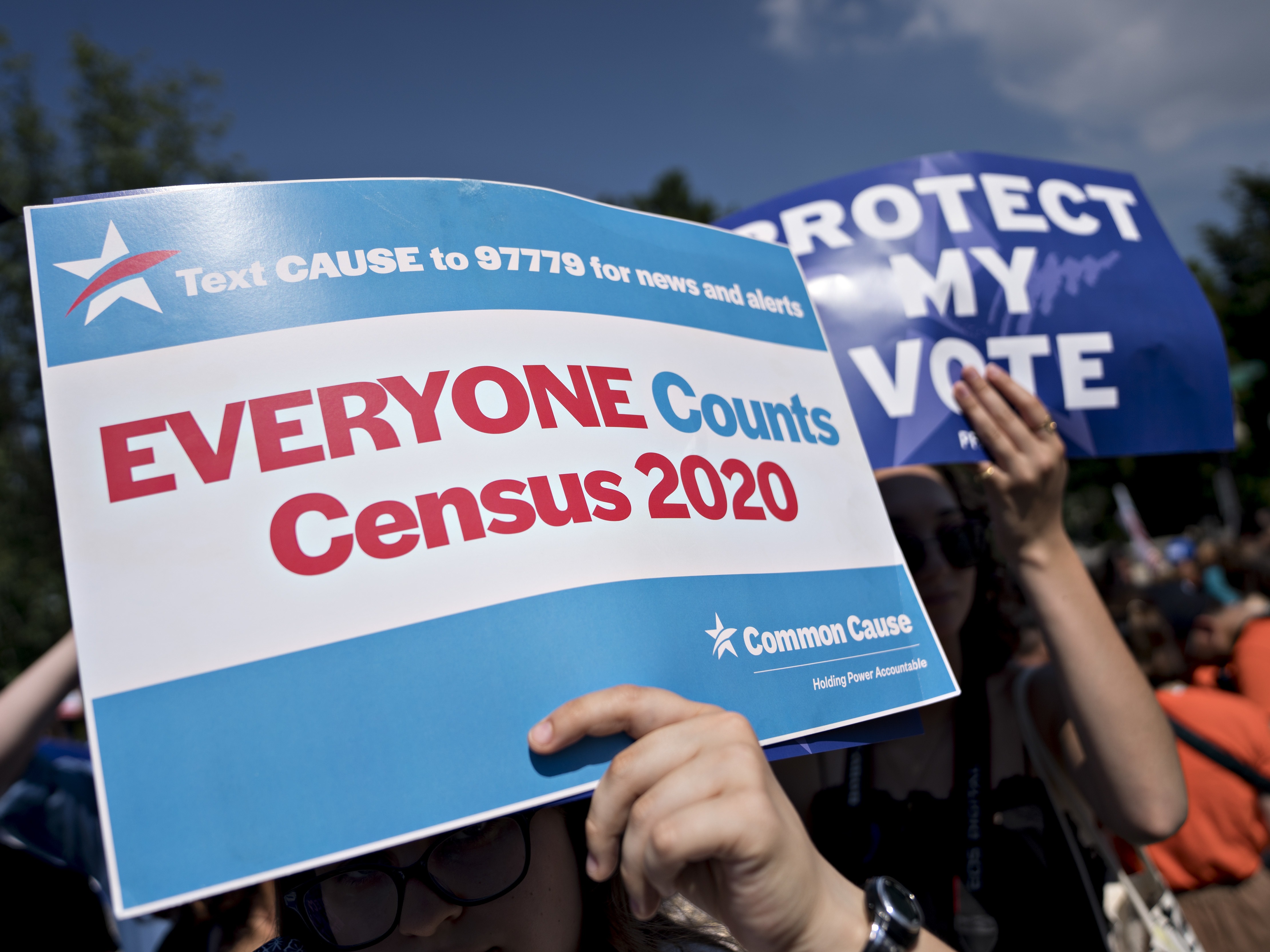 A demonstrator holds a sign about the U.S. census outside the Supreme Court in Washington, D.C., in 2019. The Census Bureau has stopped all work on President Trump's directive to produce a count of unauthorized immigrants that could be subtracted from a key set of census numbers, NPR has learned. Andrew Harrer/Bloomberg via Getty Images