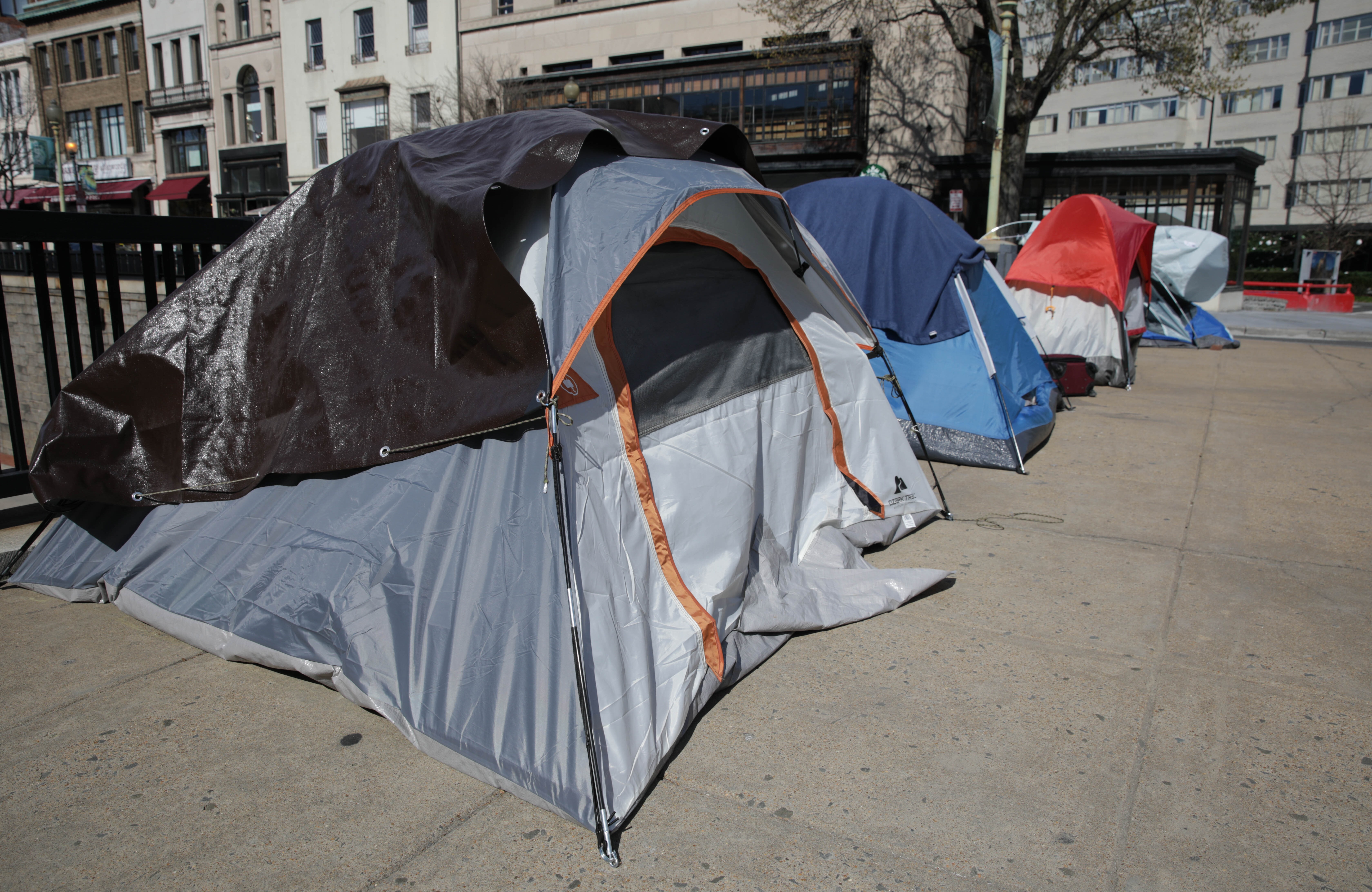 Tents of unhoused resident line a street in Washington, D.C., in April. CREDIT: Yasin Ozturk/Anadolu Agency via Getty Images