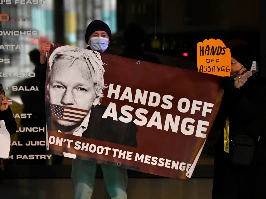 Supporters of Julian Assange with sign supporting him