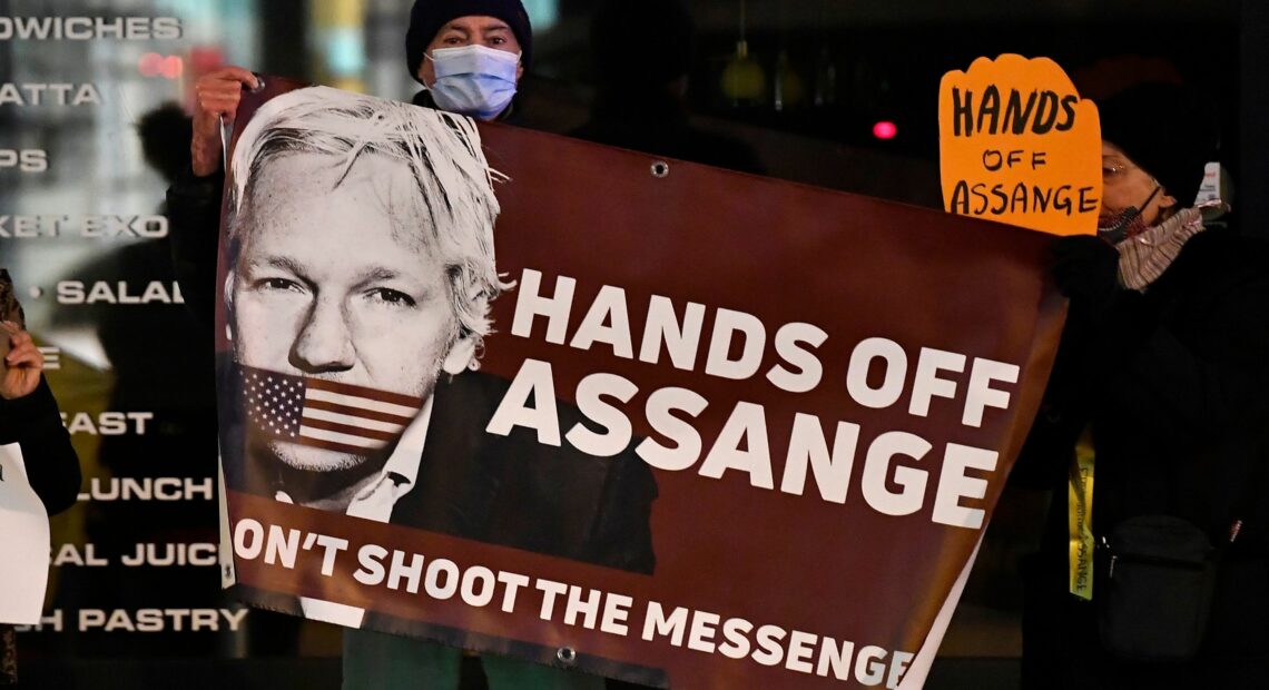 Supporters of Julian Assange with sign supporting him