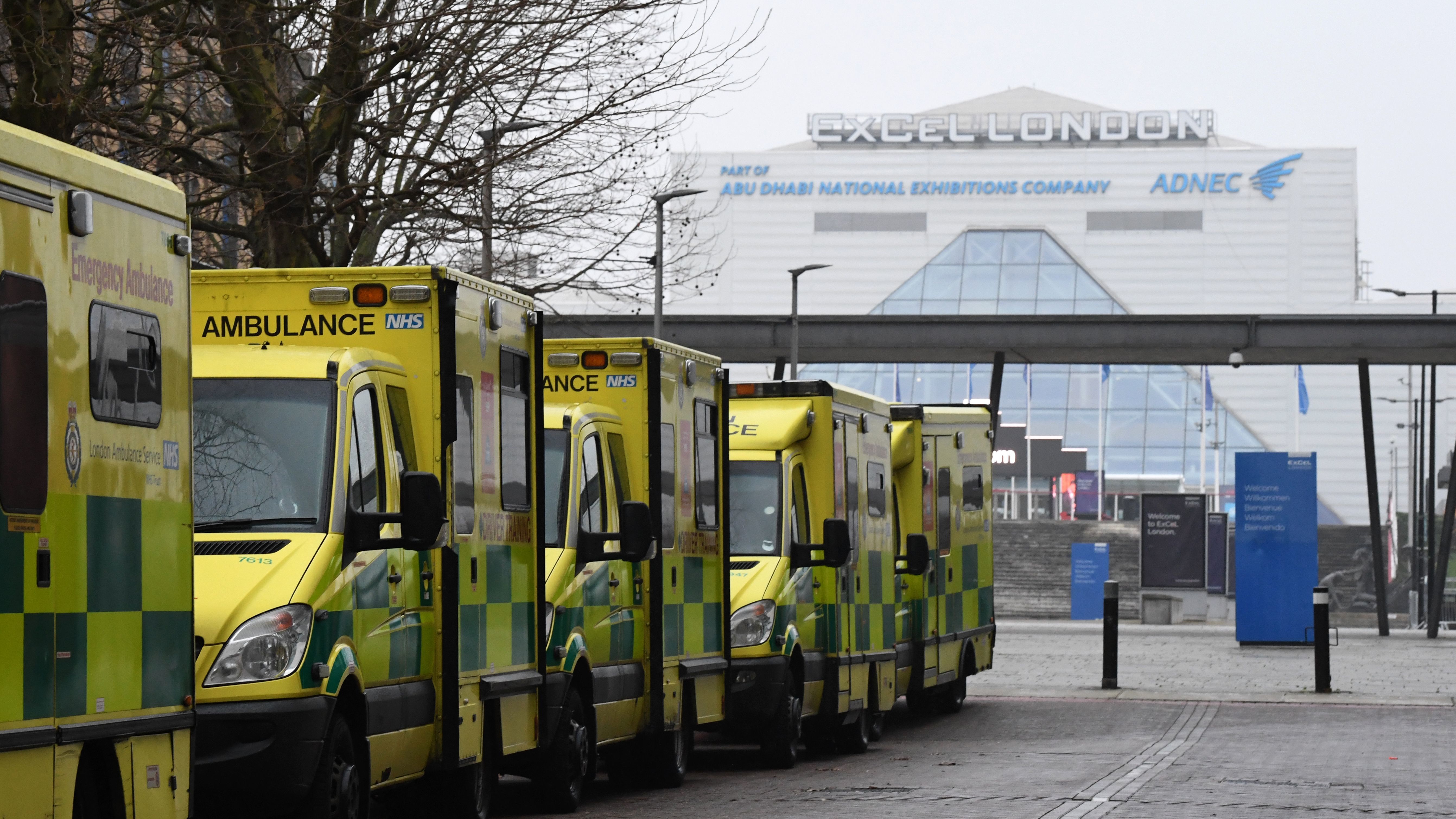 Ambulances are parked outside the NHS Nightingale hospital at the ExCeL center in east London on Friday. Hospitals in the U.K. are preparing for an influx of patients as the coronavirus continues to spread. CREDIT: Daniel Leal-Olivas/AFP via Getty Images