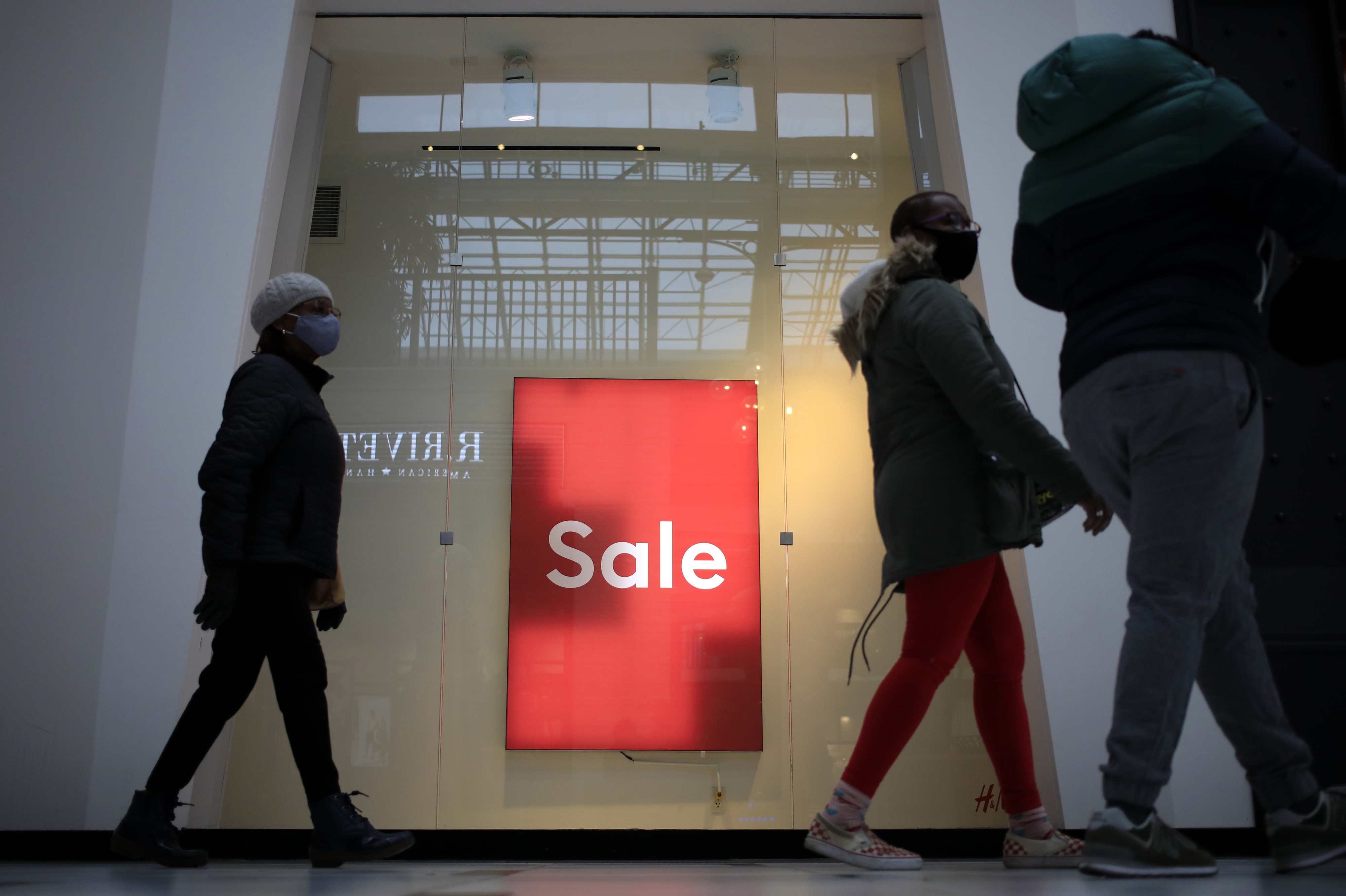 Shoppers walk past a "Sale" sign outside a store at the Easton Town Center Mall in Columbus, Ohio, on Jan. 7. CREDIT: Luke Sharrett/Bloomberg via Getty Images