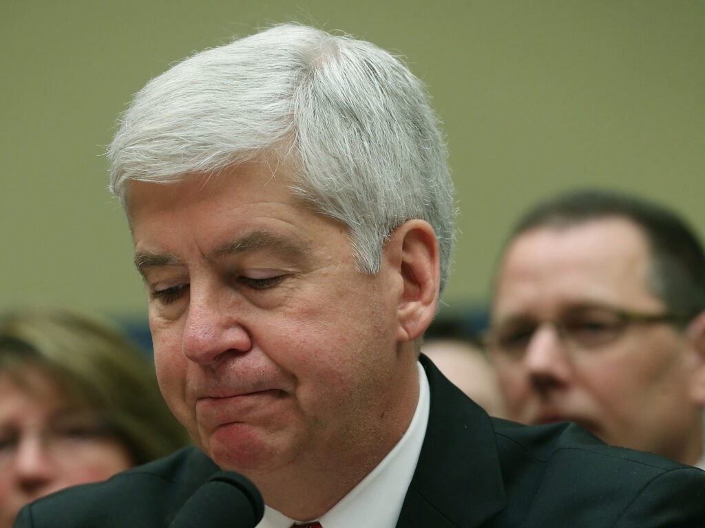 Now Former Michigan Gov. Rick Snyder, (R-MI), listens to Congressional members remarks during a House Oversight and Government Reform Committee hearing, about the Flint, Mich. water crisis in 2016. Mark Wilson/Getty Images