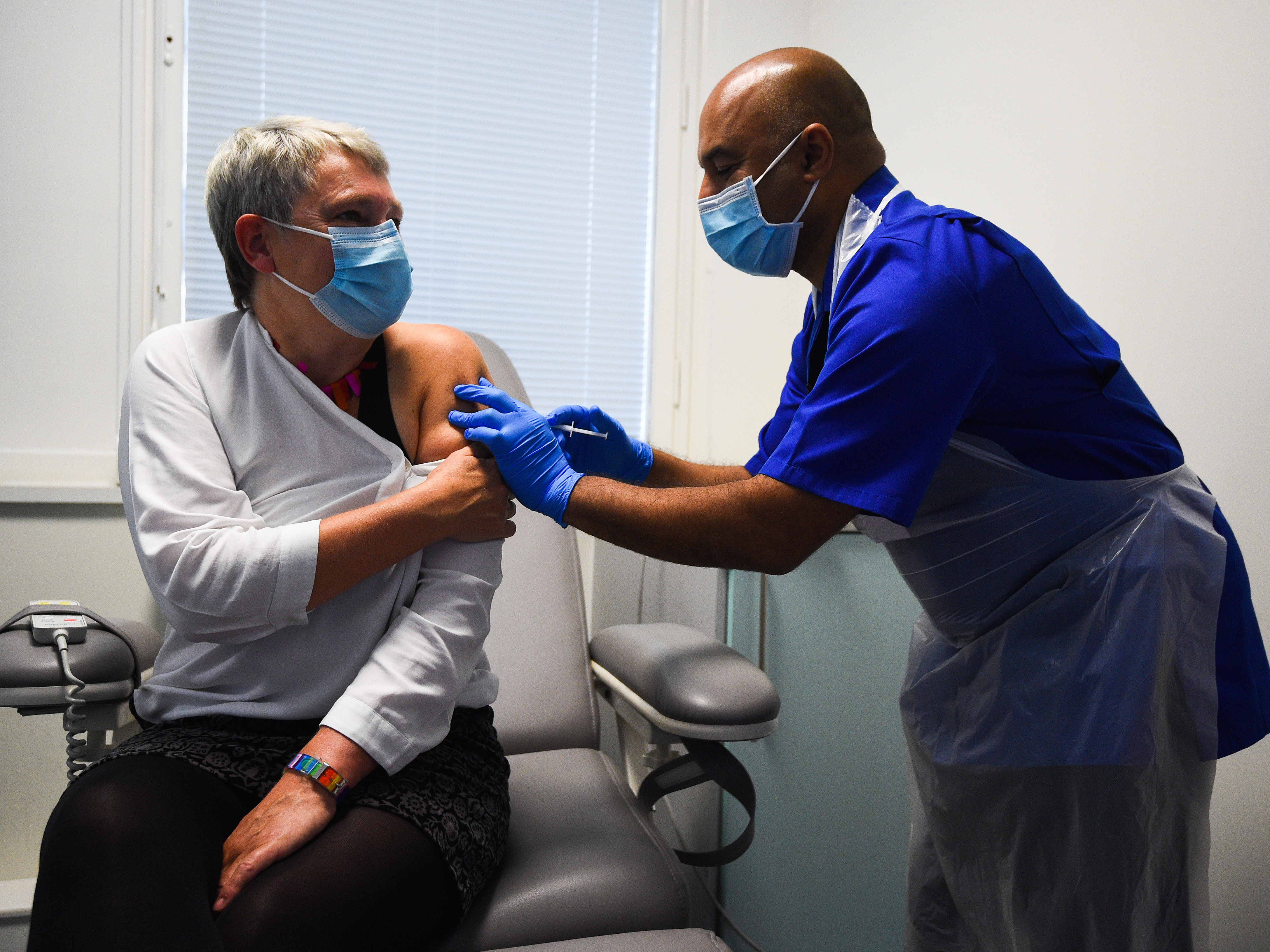 Nurse Vash Deelchand inoculated Kate Bingham, chair of the U.K. government's vaccine task force, with a Novavax vaccine at the Royal Free Hospital in London in October. CREDIT: Kirsty O'Connor - PA Images/PA Images via Getty Images