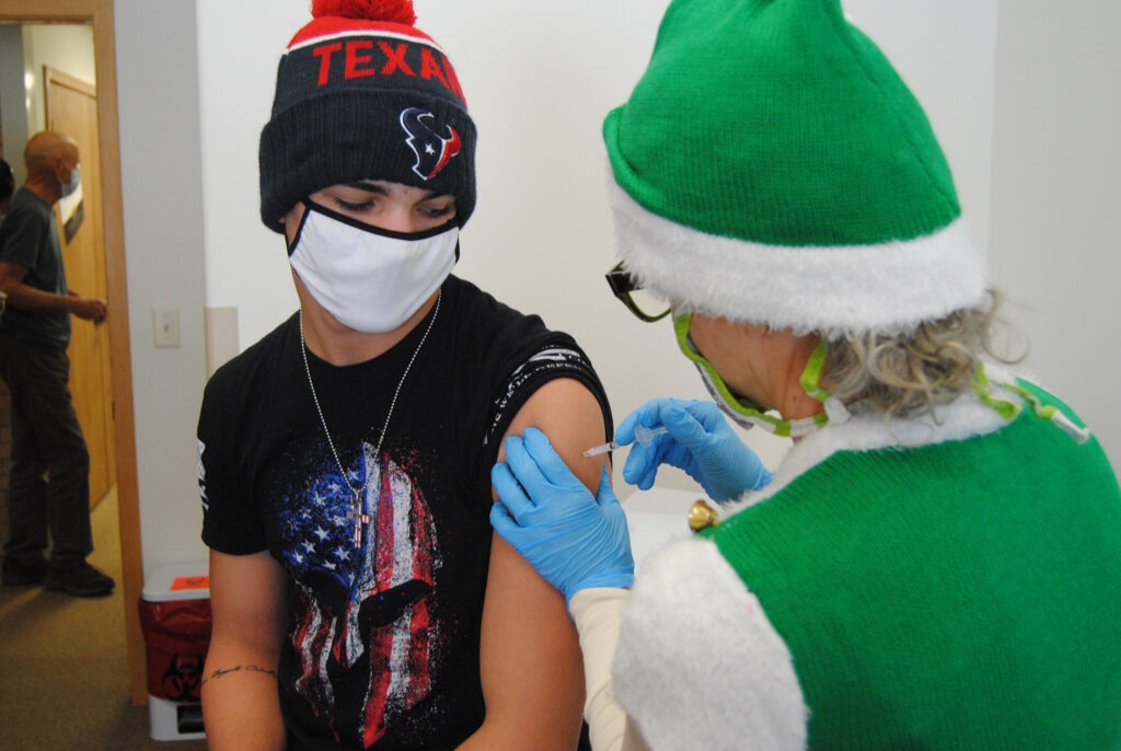 Gene Bracegirdle getting a COVID-19 vaccine shot