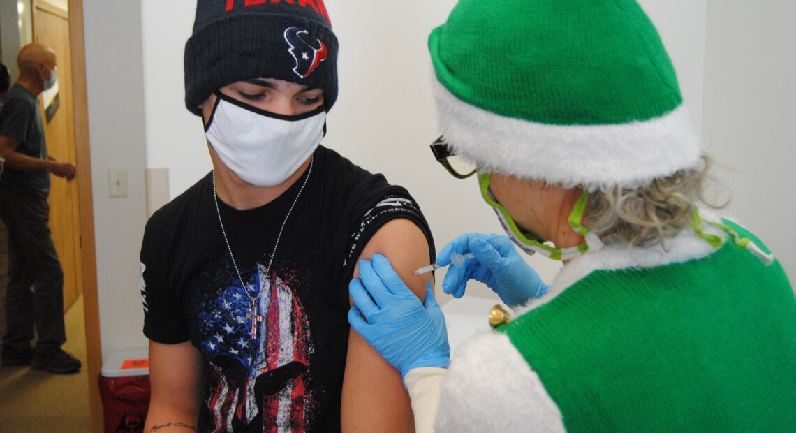 Gene Bracegirdle getting a COVID-19 vaccine shot