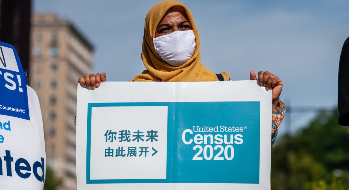 A census supporter holds up a sign during a 2020 rally in New York City. CREDIT: Gabriele Holtermann-Gorden/Sipa USA via Reuters
