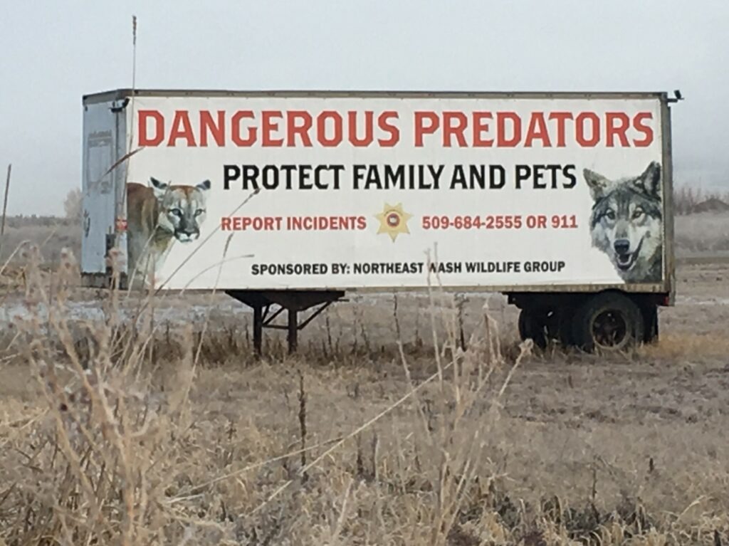 A sign on the side of trailer in Stevens County, Washington, near Chewelah off U.S. Highway 395 prompts people to report 