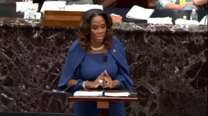 Del. Stacey Plaskett of the U.S. Virgin Islands, a House impeachment manager, played senators new video and audio footage documenting the violent mayhem of the insurrection at the U.S. Capitol on Jan. 6. CREDIT: Handout/Getty Images