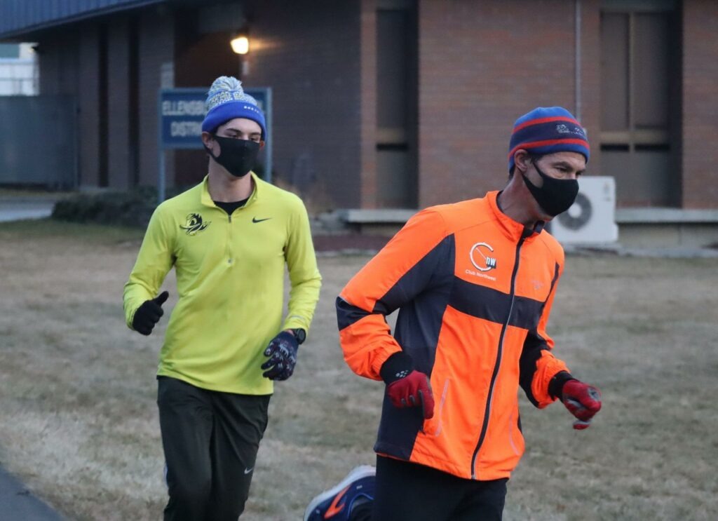 Coach Jeff Hashimoto, right, and high school senior Bryton Wilson finish a masked training run in Ellensburg on Monday. CREDIT: Tom Banse/N3