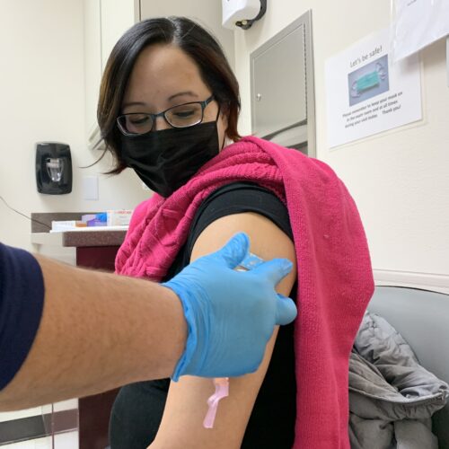 Amanda Bordeaux, 36, gets her second dose of the Pfizer vaccine during a weekly mass vaccination clinic at the Rosebud hospital in South Dakota. Kirk Siegler/NPR
