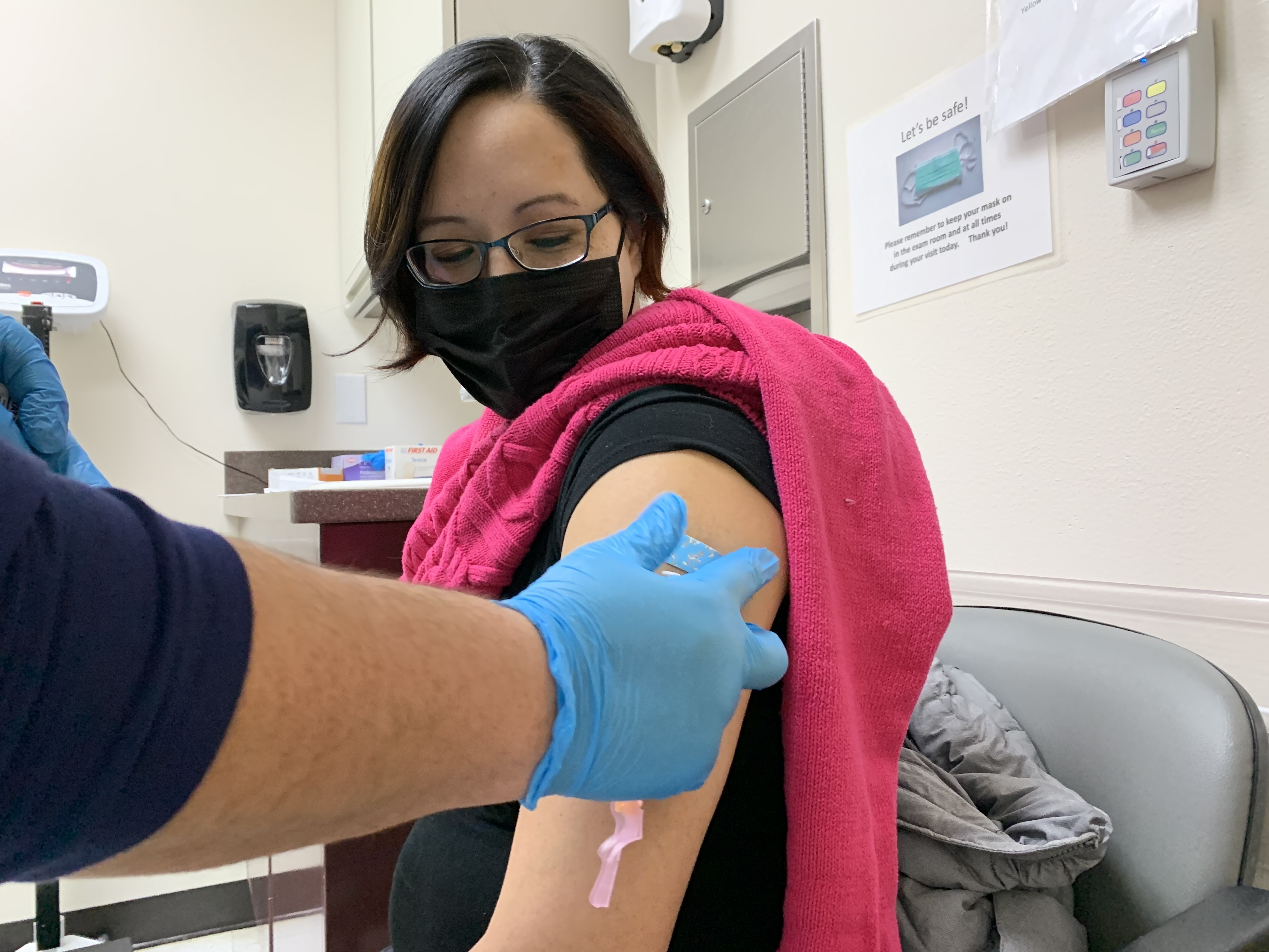 Amanda Bordeaux, 36, gets her second dose of the Pfizer vaccine during a weekly mass vaccination clinic at the Rosebud hospital in South Dakota. Kirk Siegler/NPR