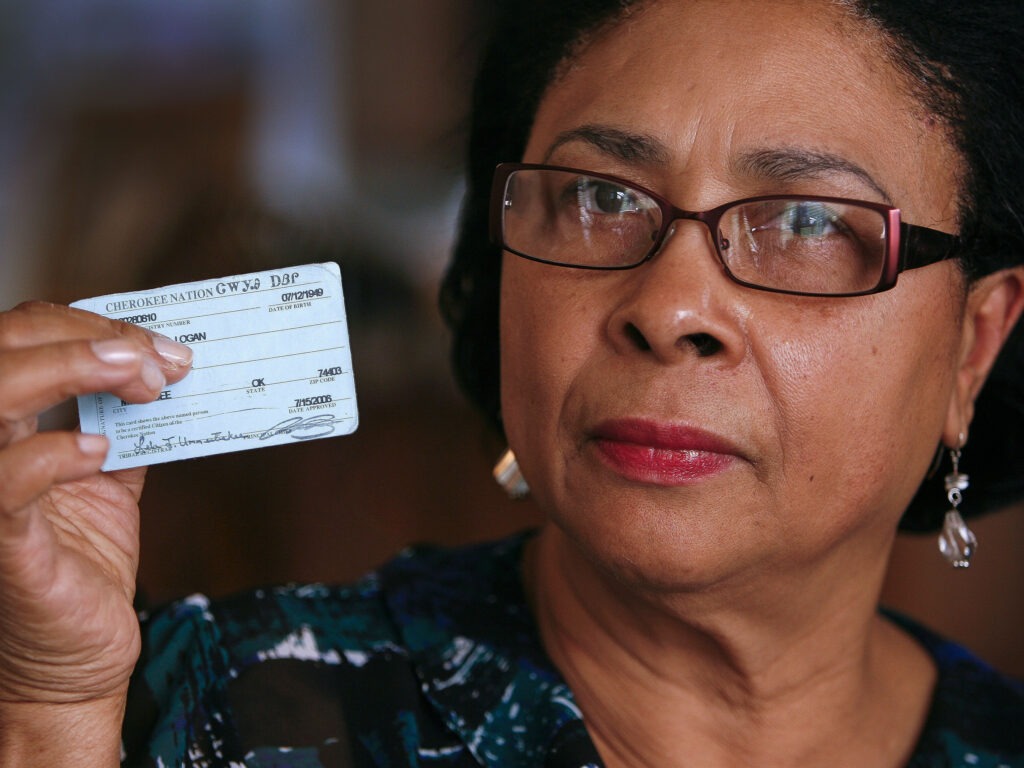 Rena Logan, a member of a Cherokee Freedmen family, shows her identification card as a member of the Cherokee tribe at her home in Muskogee, Okla., in this photo from October 2011. She is among the some 8,500 people whose ancestors were enslaved by the Cherokee Nation in the 1800s. CREDIT: David Crenshaw/AP