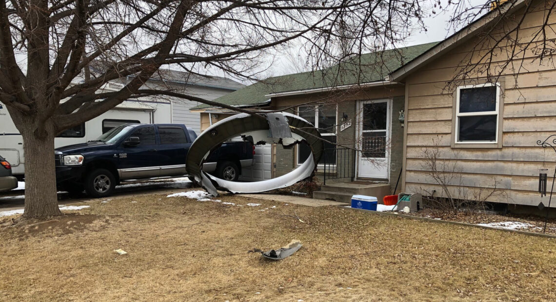 Debris is scattered in the front yard of a house in Broomfield, Colo., Saturday. A commercial airliner dropped debris in Colorado neighborhoods during an emergency landing Saturday. Broomfield Police Department via AP
