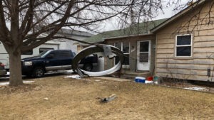 Debris is scattered in the front yard of a house in Broomfield, Colo., Saturday. A commercial airliner dropped debris in Colorado neighborhoods during an emergency landing Saturday. Broomfield Police Department via AP