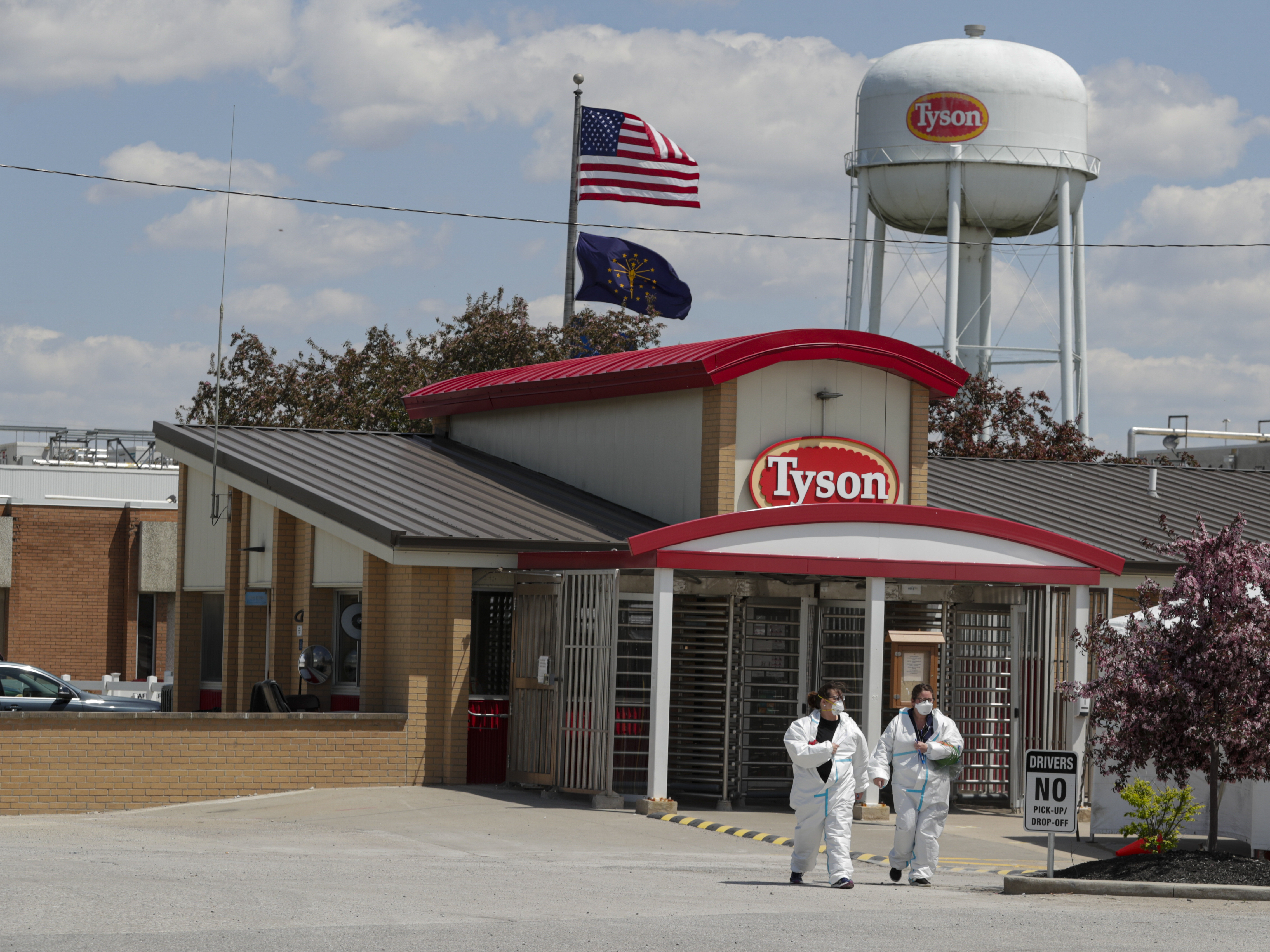 Workers are shown leaving the Tyson Foods pork processing plant in Logansport, Ind., in May. A House subcommittee is investigating the Trump administration's handling of COVID-19 outbreaks at meatpacking plants, focusing on the Occupational Safety and Health Administration as well as major companies Tyson, Smithfield and JBS. CREDIT: Michael Conroy/AP