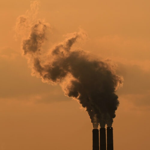 Smokestacks at the Jeffrey Energy Center coal-fired power plant are silhouetted against the sky at sunset in September near Emmet, Kan. CREDIT: Charlie Riedel/AP